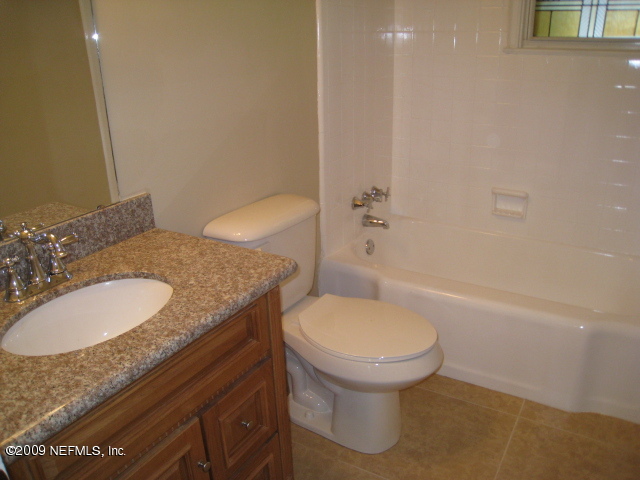 1759 Mayfair Road Jacksonville, FL 32207 - Photo 11 of 17 a bathroom with a granite countertop sink and a mirror