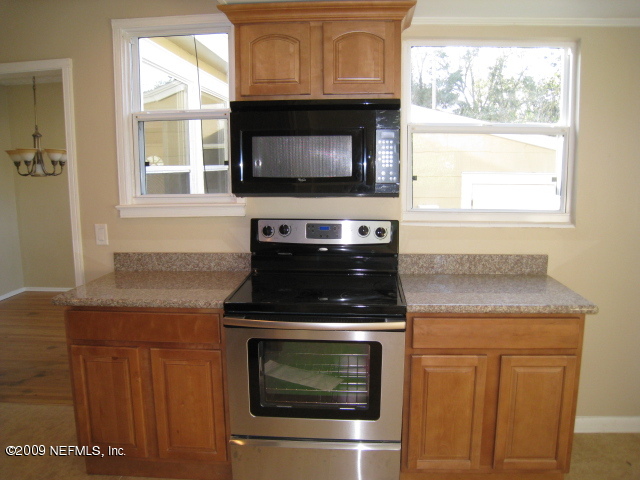 1759 Mayfair Road Jacksonville, FL 32207 - Photo 6 of 17 a kitchen with granite countertop white cabinets appliances and a sink