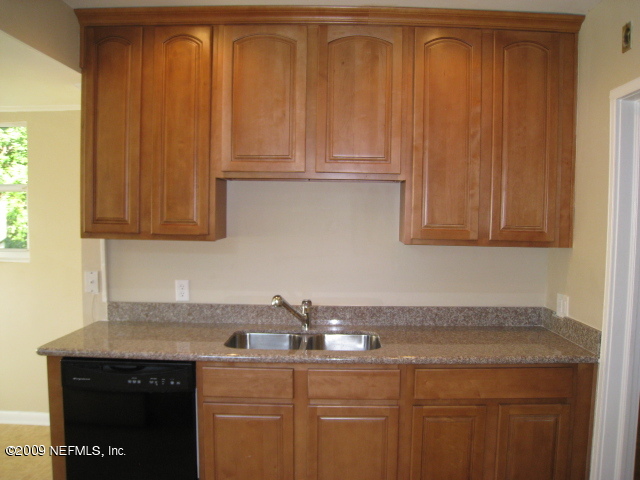 1759 Mayfair Road Jacksonville, FL 32207 - Photo 7 of 17 a kitchen with stainless steel appliances granite countertop a sink and cabinets