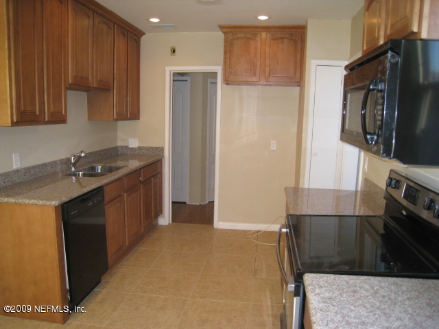 1759 Mayfair Road Jacksonville, FL 32207 - Photo 8 of 17 a kitchen with stainless steel appliances granite countertop a refrigerator a stove and a sink