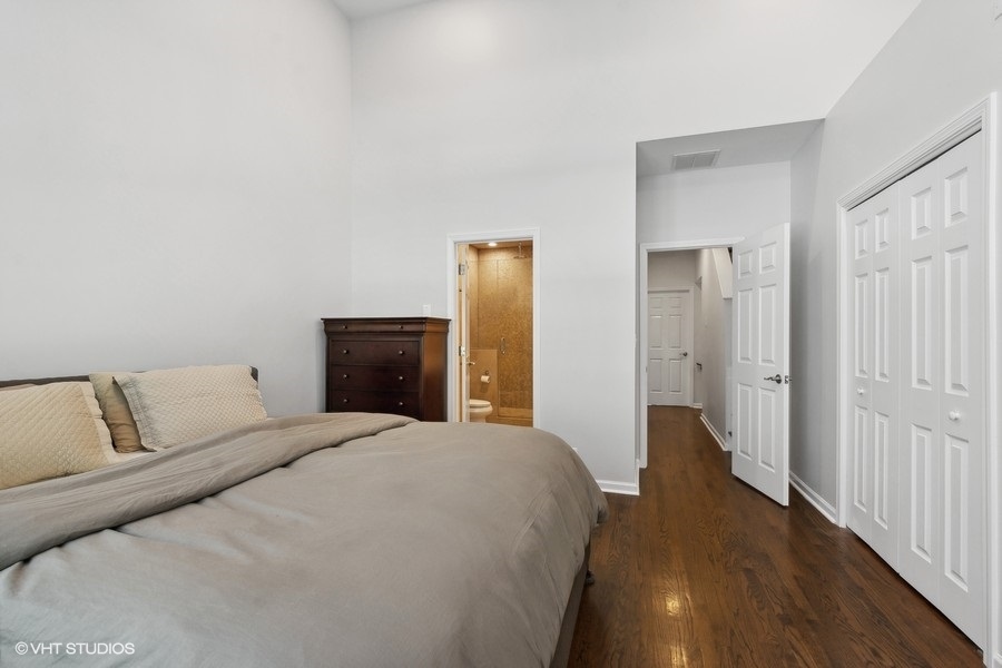 1455 South Indiana Avenue Chicago, IL 60605 - Photo 15 of 27 a bedroom with a bed and wooden floor