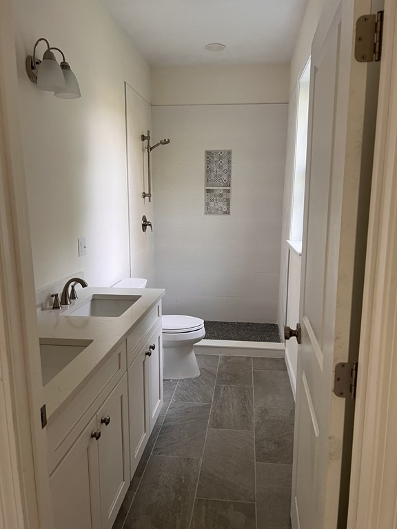 41 Brookside Avenue Webster, MA 01570 - Photo 12 of 17 a bathroom with a granite countertop sink a toilet and shower