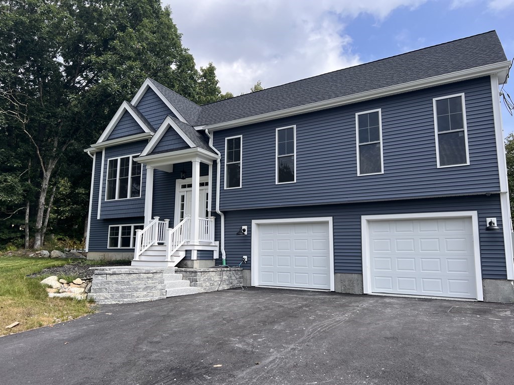 41 Brookside Avenue Webster, MA 01570 - Photo 3 of 17 a front view of a house with a yard and garage