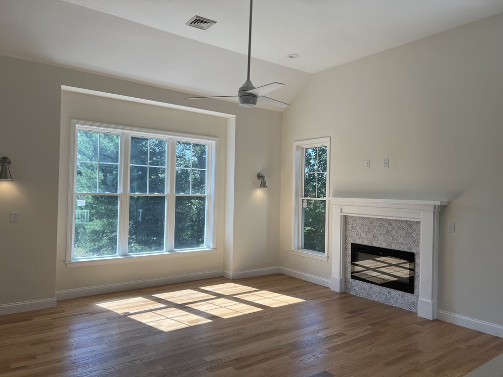 41 Brookside Avenue Webster, MA 01570 - Photo 7 of 17 a view of an empty room with wooden floor fireplace and a window