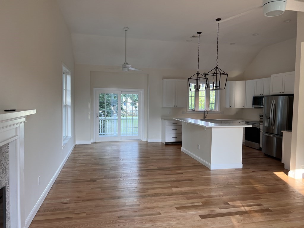 41 Brookside Avenue Webster, MA 01570 - Photo 8 of 17 a kitchen with stainless steel appliances granite countertop wooden floors sink and cabinets