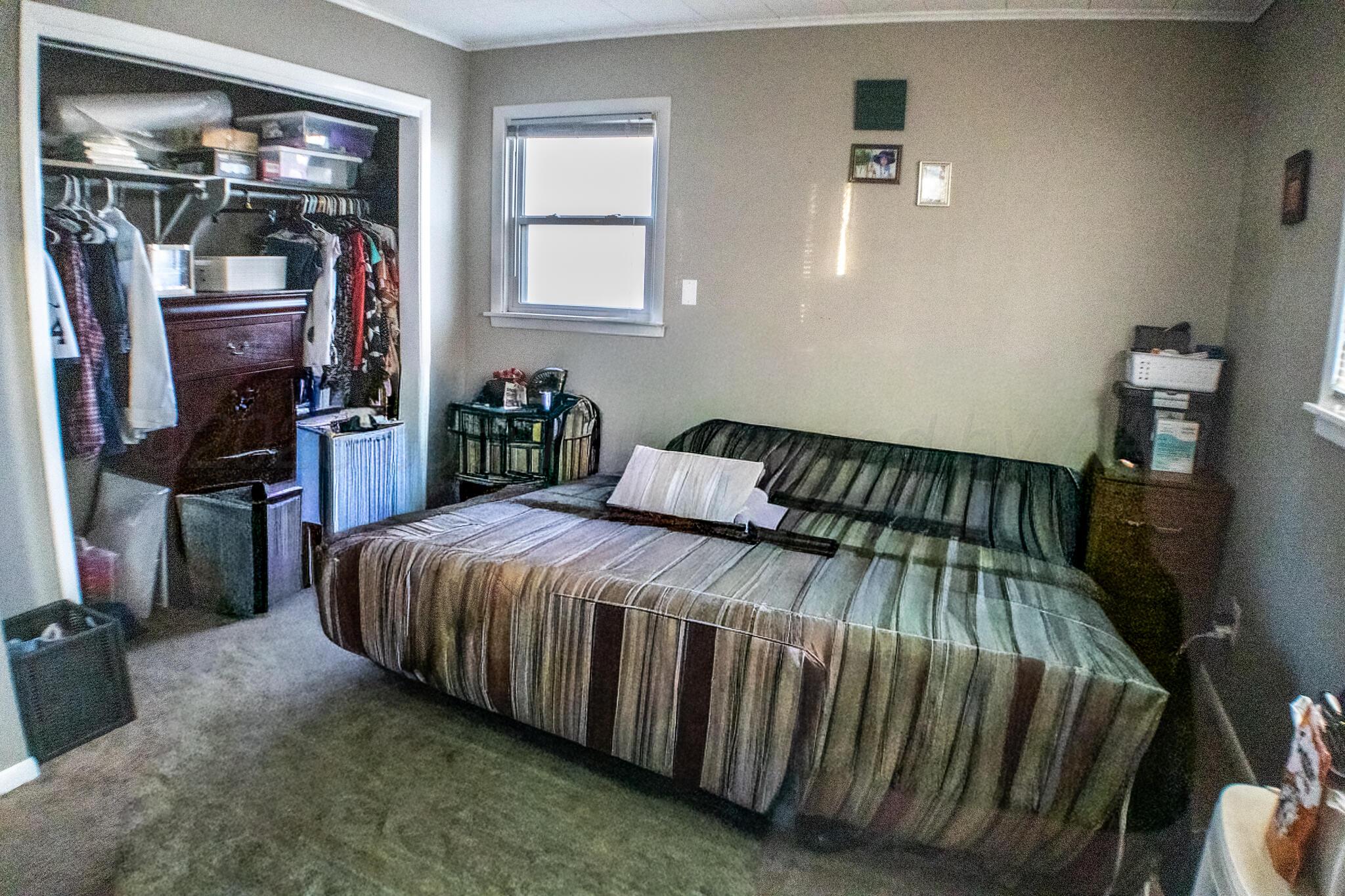 4711 South Rusk Street Amarillo, TX 79110 - Photo 21 of 24 a bedroom with a bed and walk in closet