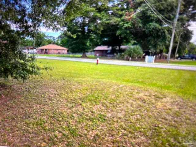 a swimming pool with outdoor seating and yard
