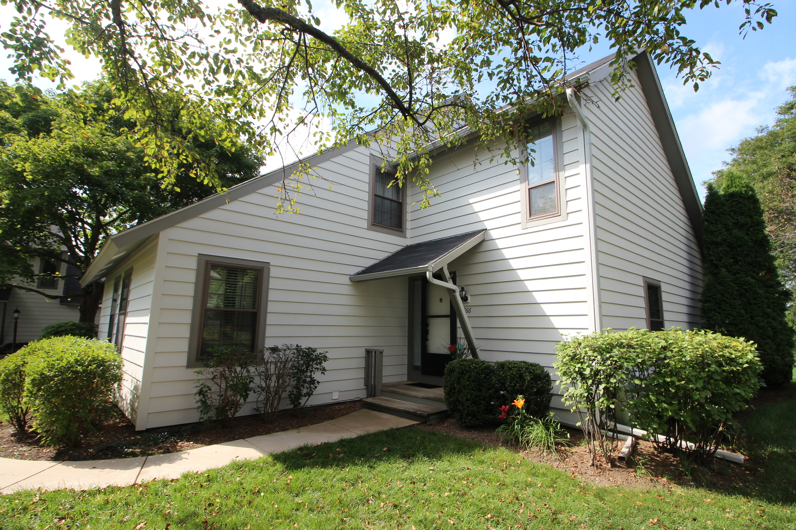766 Chandler Road Gurnee, IL 60031 - Photo 1 of 24 a view of backyard with potted plants and a large tree