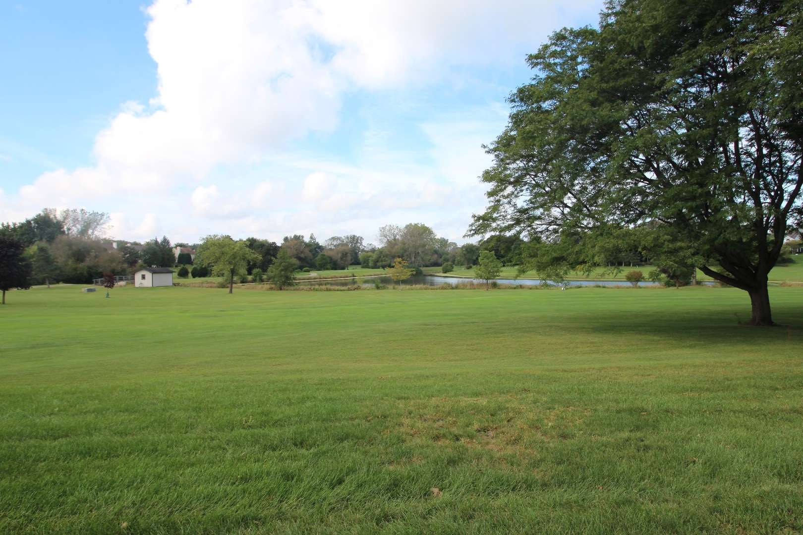 766 Chandler Road Gurnee, IL 60031 - Photo 22 of 24 a view of a green field with wooden fence