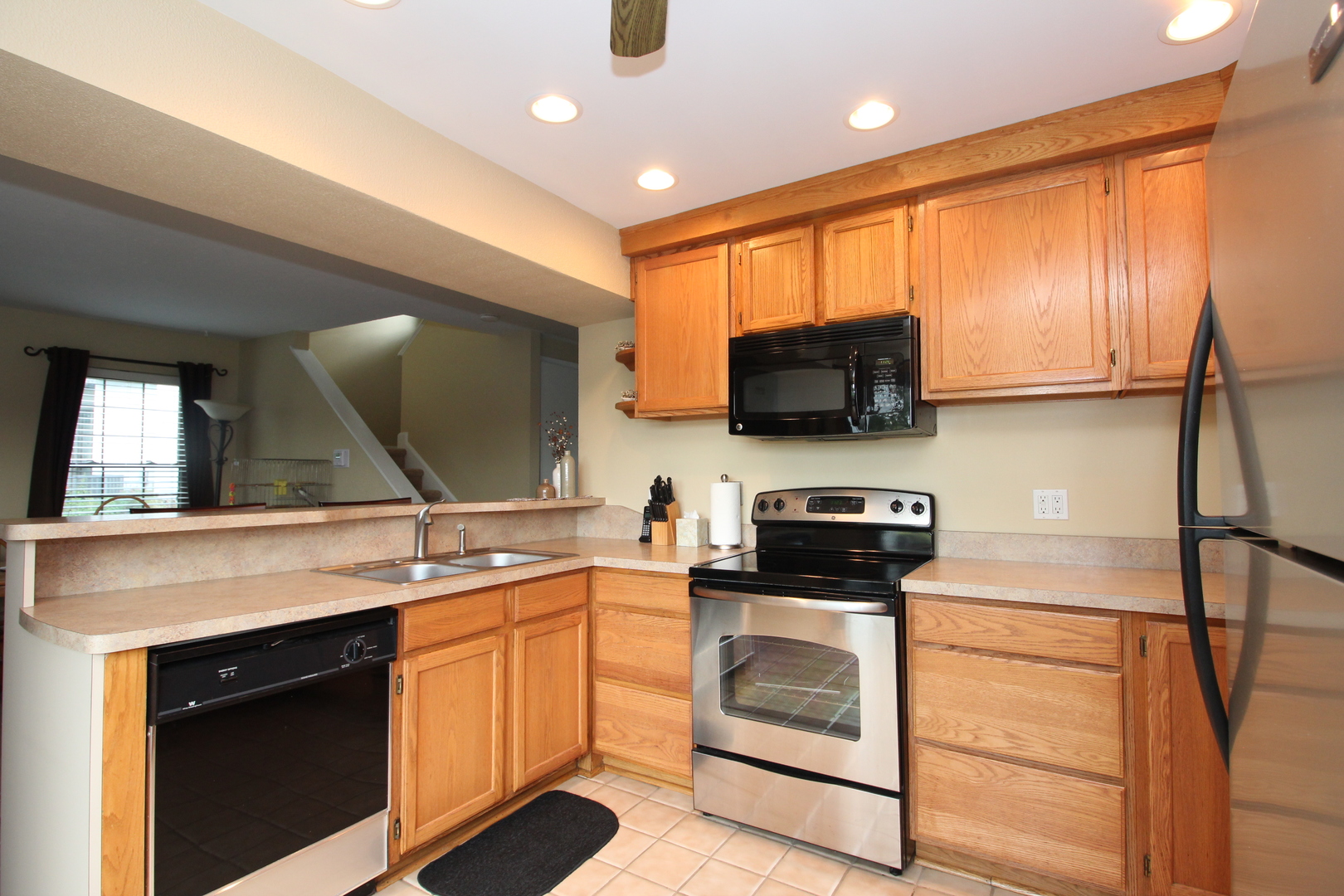 766 Chandler Road Gurnee, IL 60031 - Photo 7 of 24 a kitchen with stainless steel appliances a stove sink microwave and cabinets