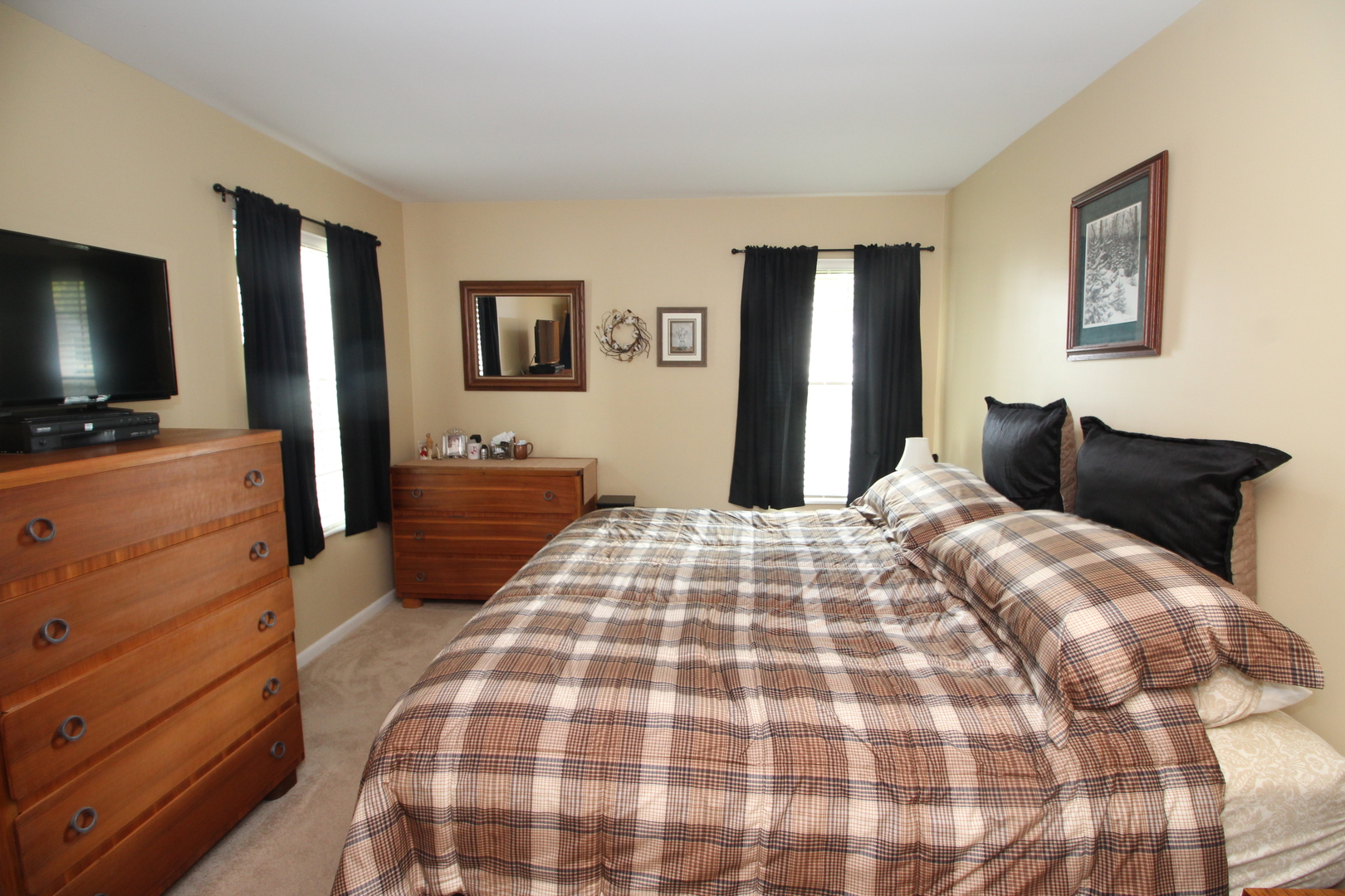 766 Chandler Road Gurnee, IL 60031 - Photo 9 of 24 a bedroom with a bed and a flat tv screen on dresser
