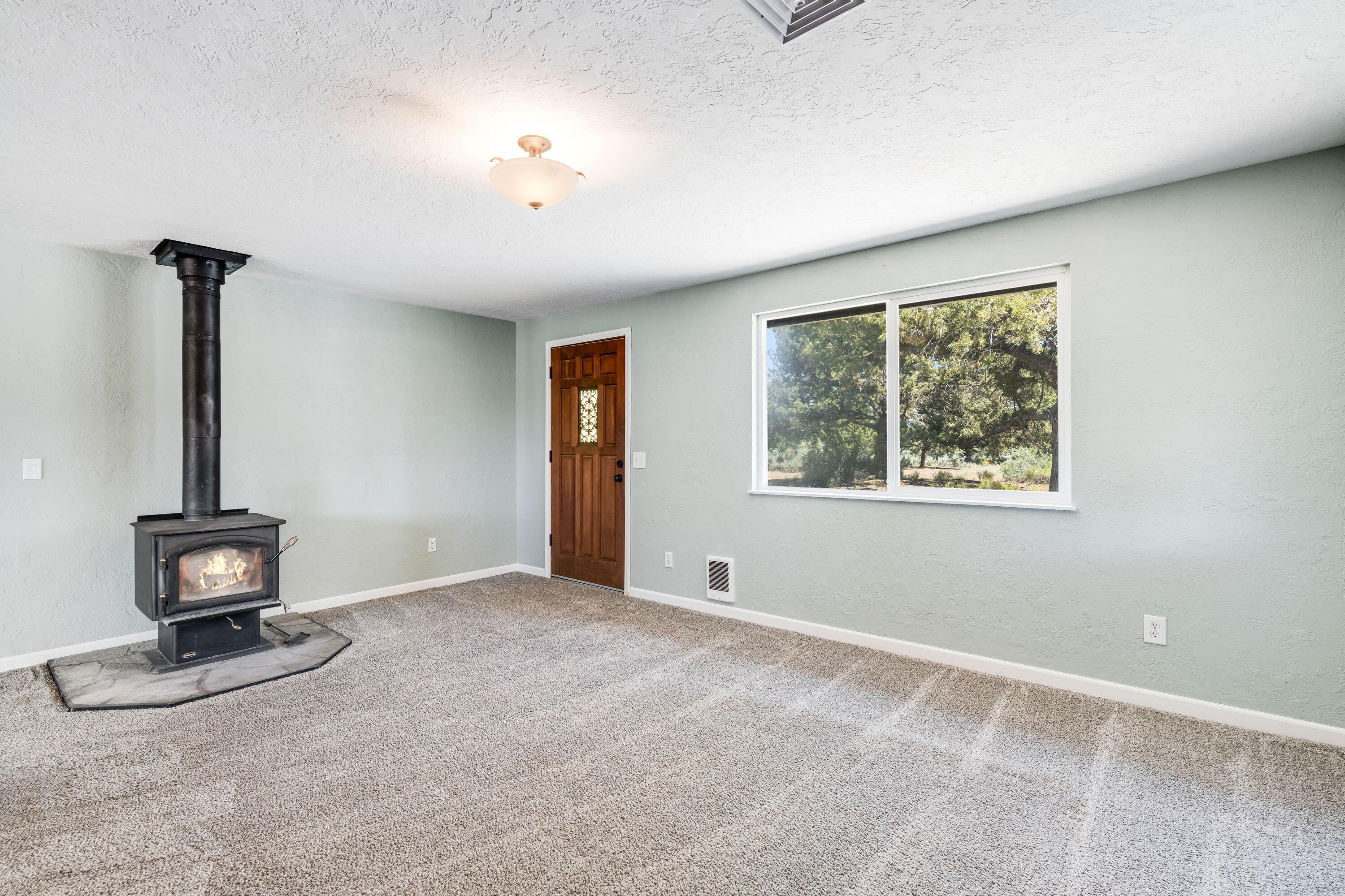 67089 Fryrear Road Bend, OR 97703 - Photo 11 of 41 Living Room with wood burning stove