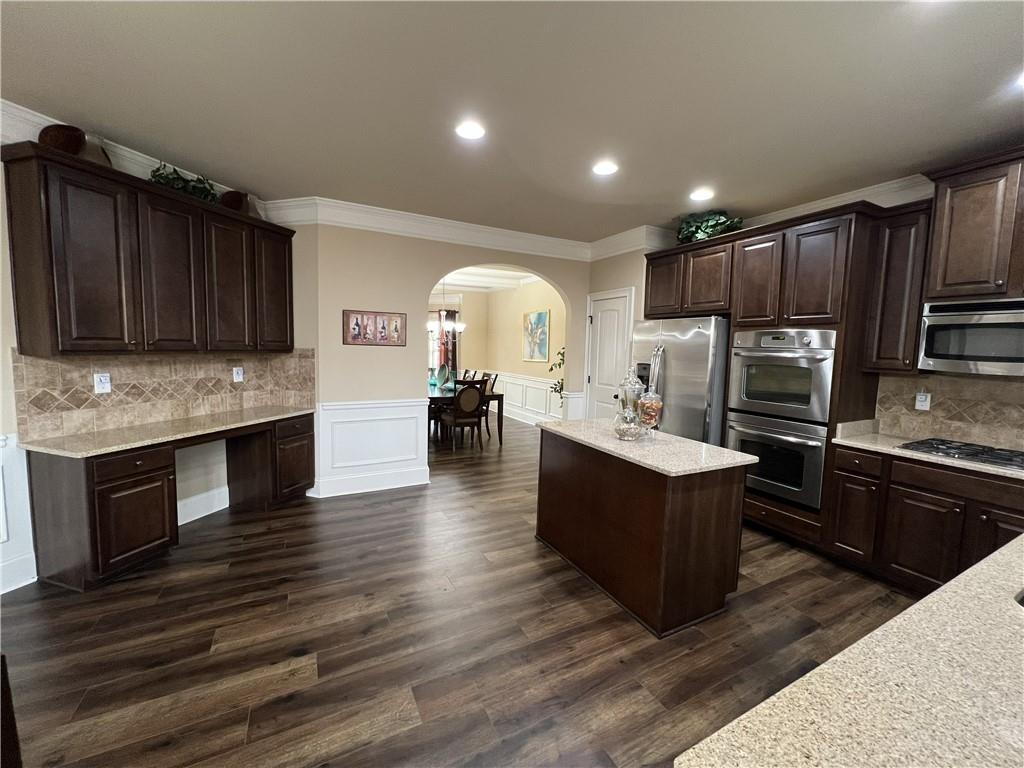 140 Providence Parkway Covington, GA 30014 - Photo 11 of 24 a large kitchen with wooden floors stainless steel appliances and cabinets