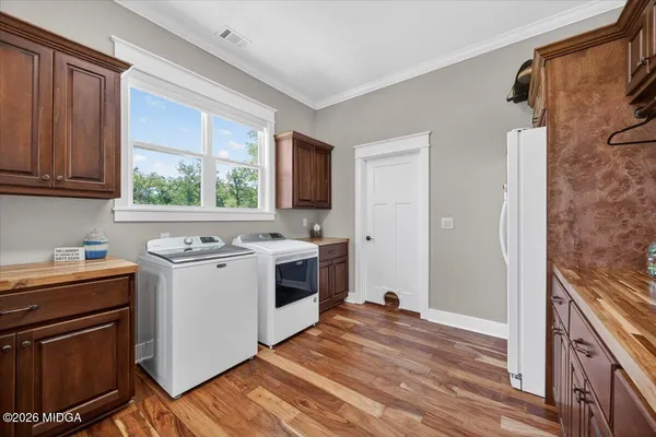 a bedroom with a bed a flat screen tv and a large window with the garden view