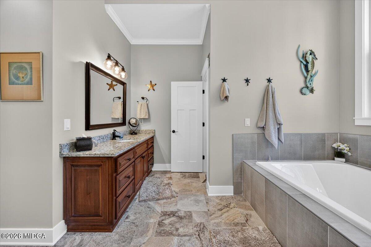 7287 Moseley Dixon Road Macon, GA 31220 - Photo 27 of 83 a bathroom with a granite countertop double vanity sink a mirror a bathtub and shower