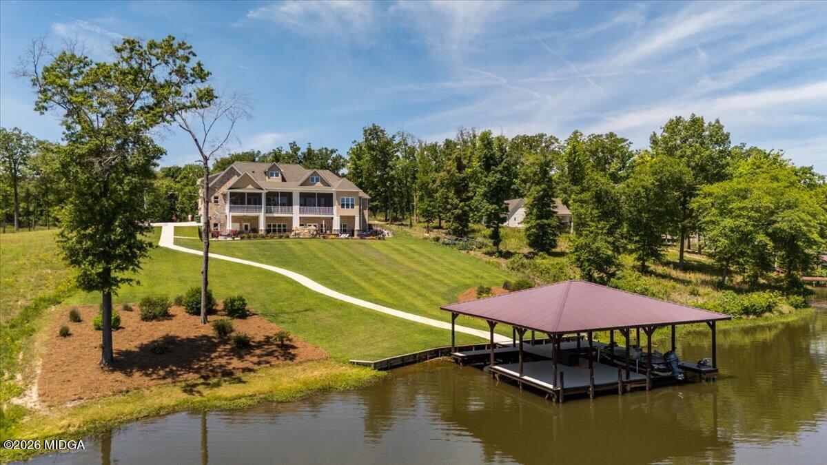 7287 Moseley Dixon Road Macon, GA 31220 - Photo 69 of 83 a view of a swimming pool with a table and chairs under an umbrella