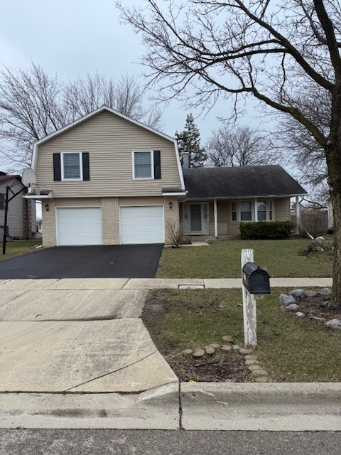 1575 Buckthorn Drive Hoffman Estates, IL 60192 - Photo 1 of 6 a front view of a house with garden