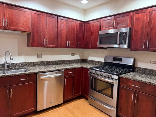 1575 Buckthorn Drive Hoffman Estates, IL 60192 - Photo 5 of 6 a kitchen with granite countertop wooden cabinets and stainless steel appliances