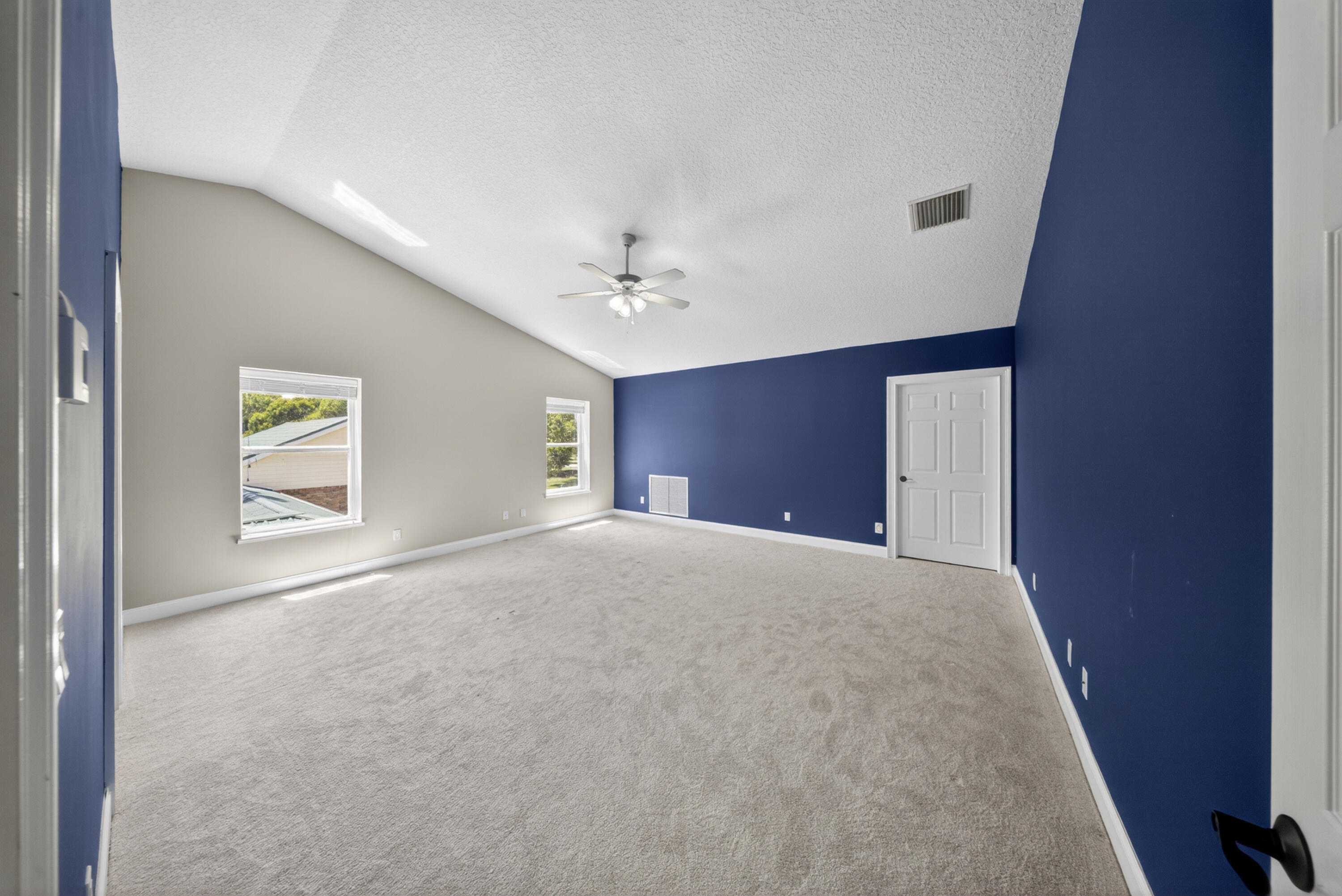8686 Andrews Avenue Fort Pierce, FL 34945 - Photo 49 of 76 a view of a big room with windows and a chandelier fan