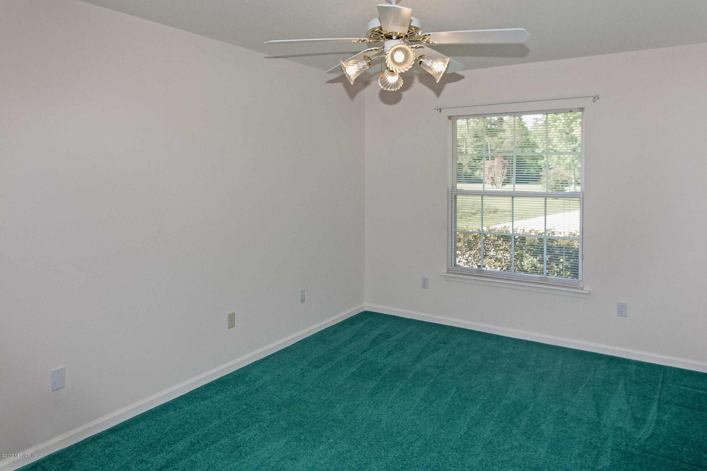 75109 Edwards Road Yulee, FL 32097 - Photo 15 of 30 a view of a big room with windows and chandelier fan
