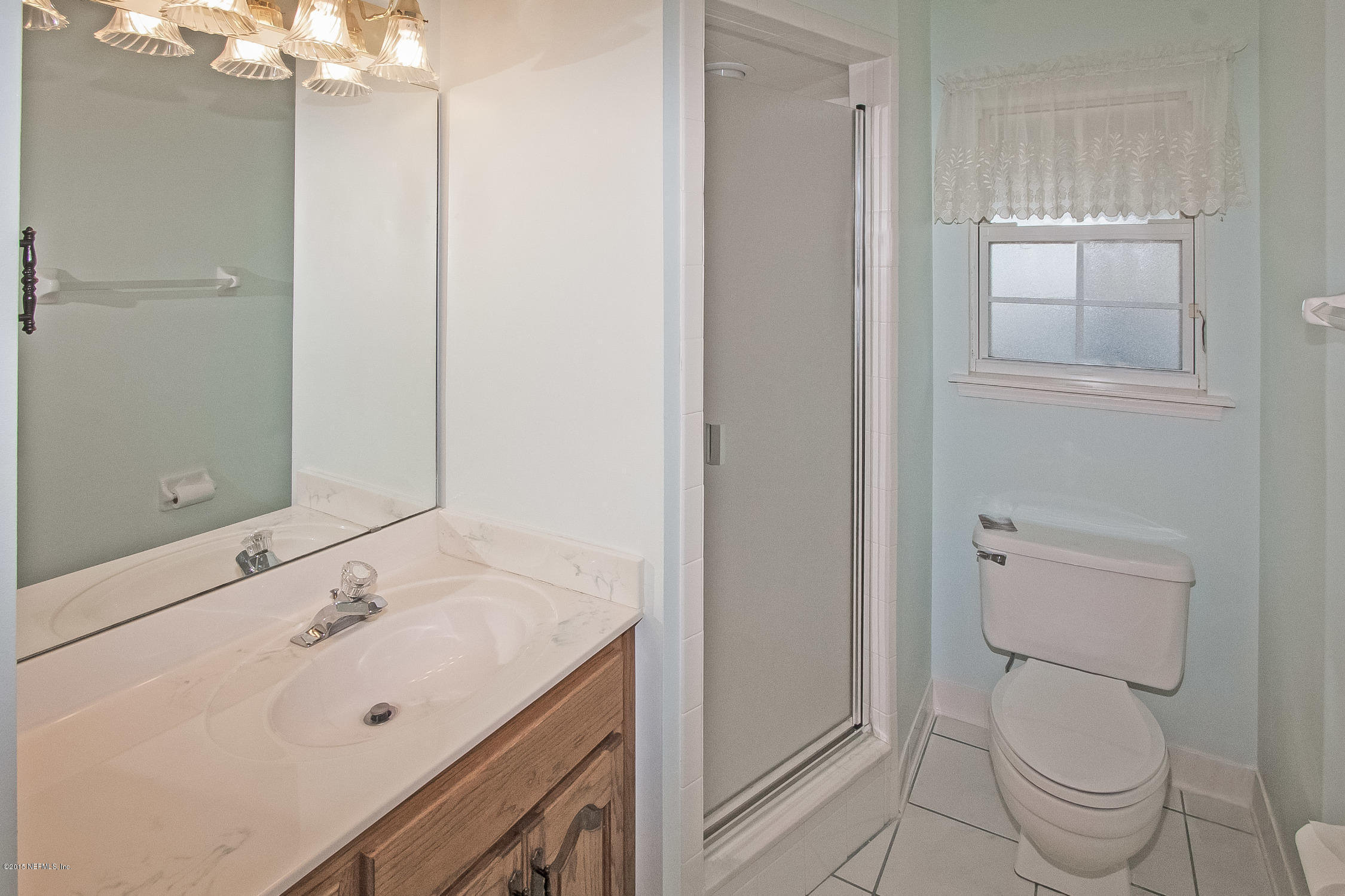 75109 Edwards Road Yulee, FL 32097 - Photo 17 of 30 a bathroom with a sink a toilet and shower