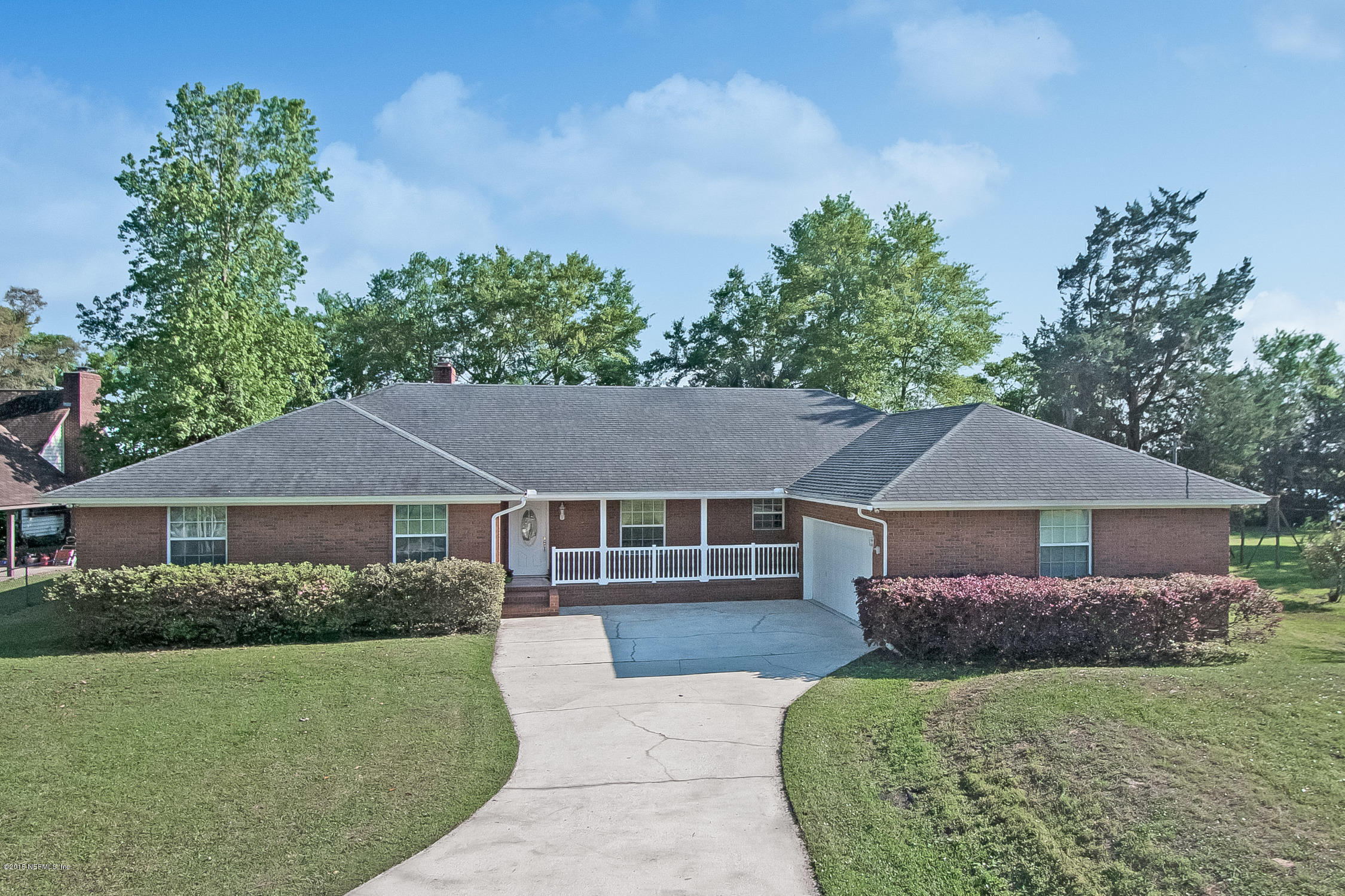 75109 Edwards Road Yulee, FL 32097 - Photo 2 of 30 a front view of a house with a yard and trees
