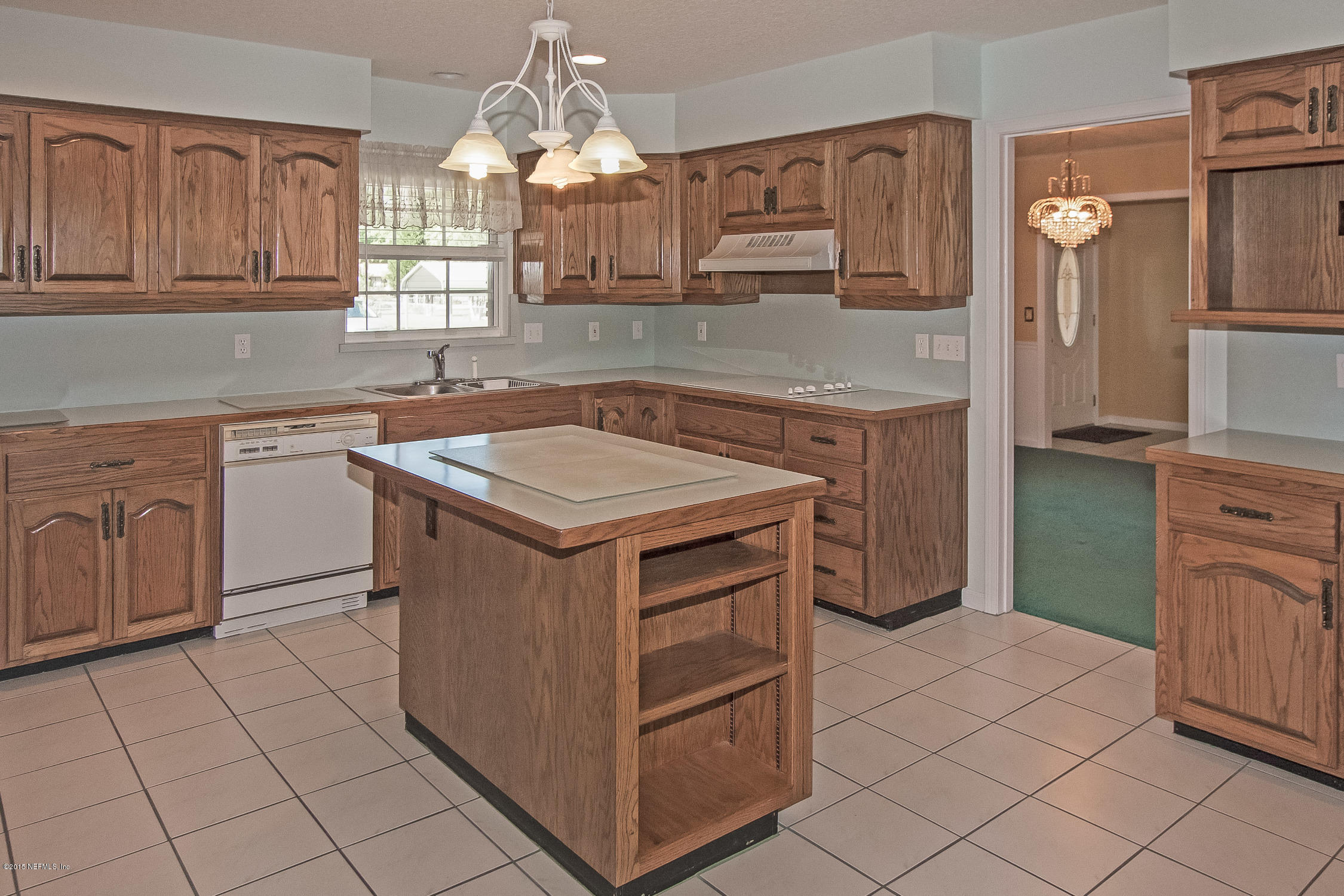 75109 Edwards Road Yulee, FL 32097 - Photo 5 of 30 a kitchen with stainless steel appliances granite countertop a stove a sink and a microwave