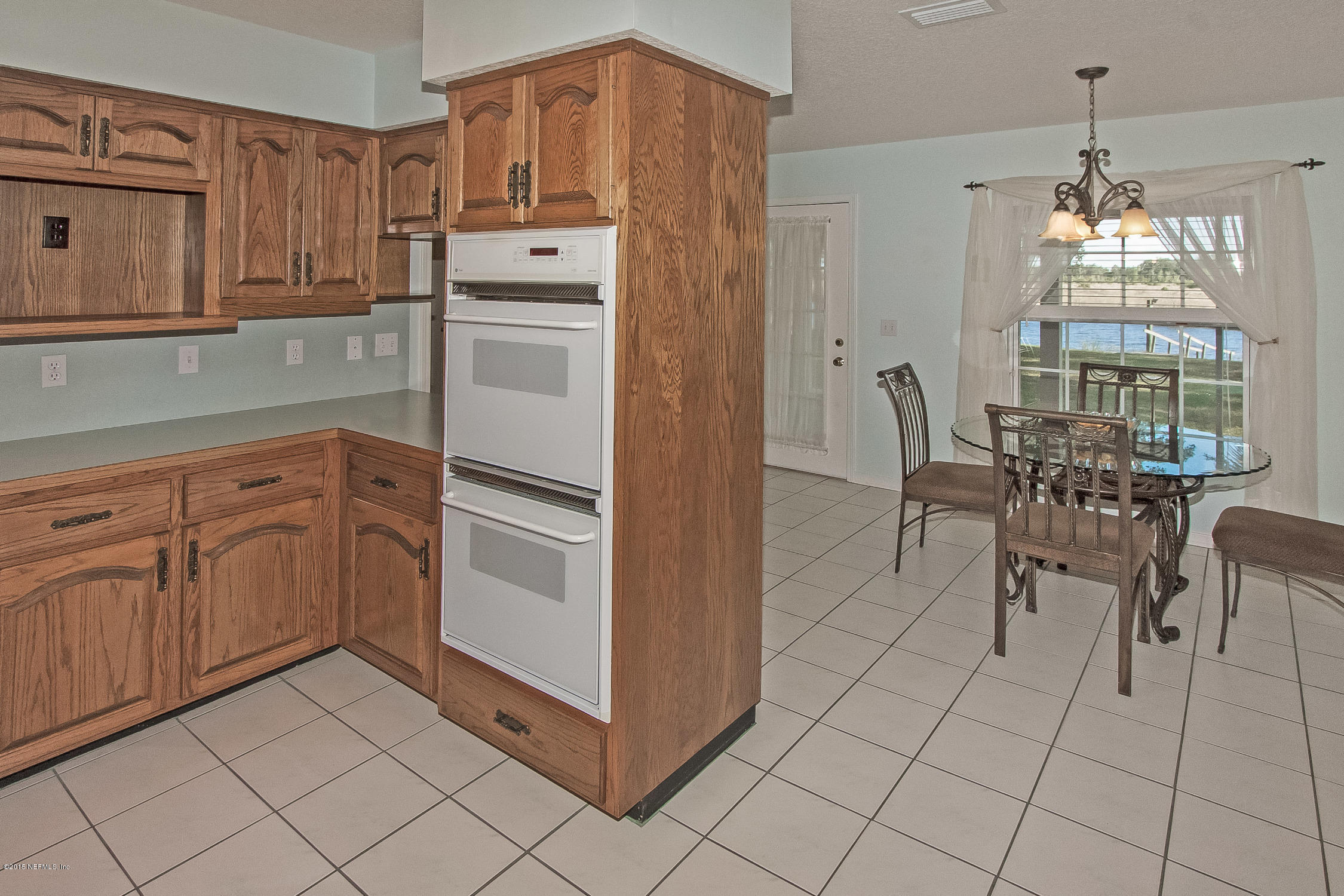 75109 Edwards Road Yulee, FL 32097 - Photo 6 of 30 a kitchen with white cabinets and white appliances