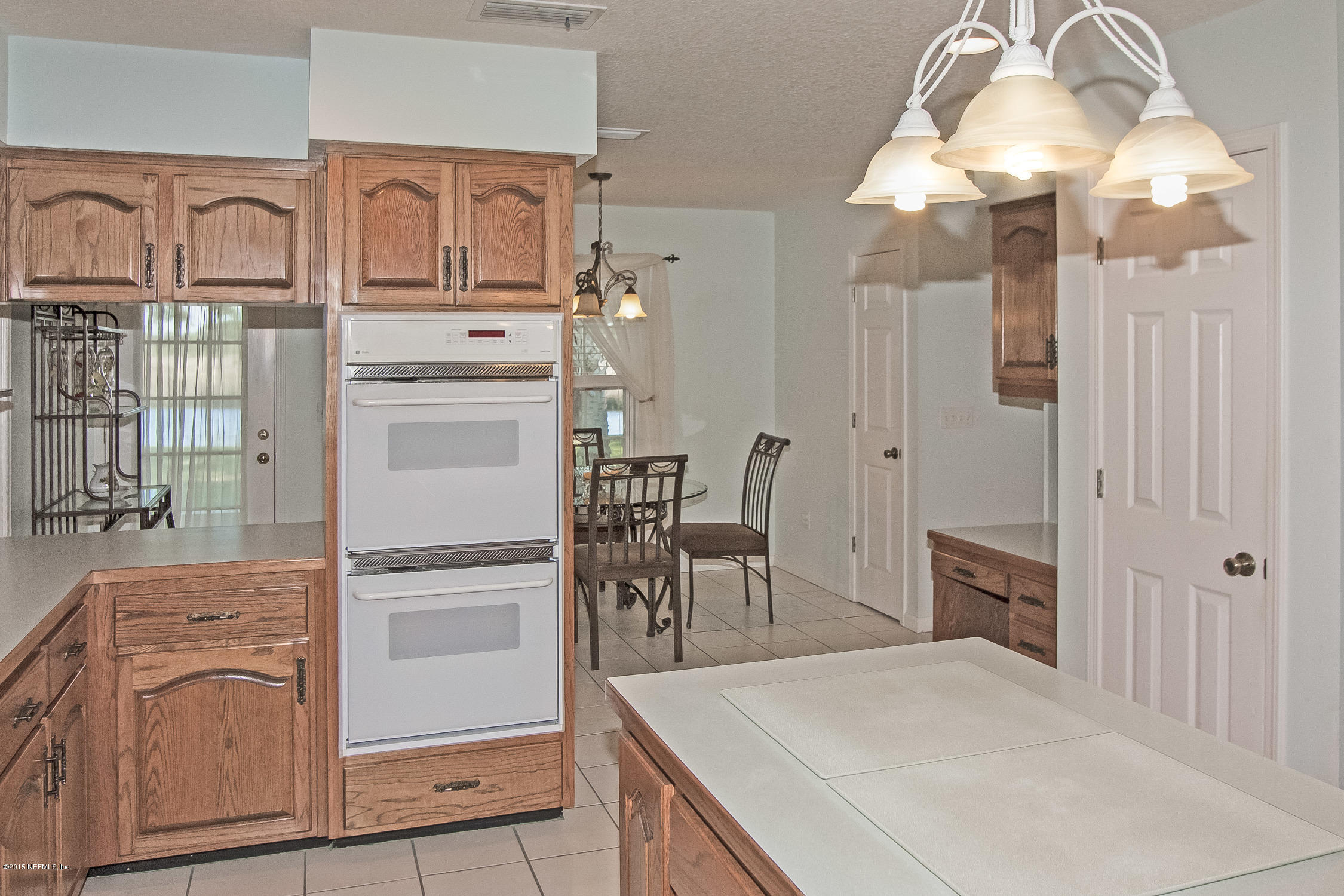 75109 Edwards Road Yulee, FL 32097 - Photo 7 of 30 a kitchen with cabinets and window