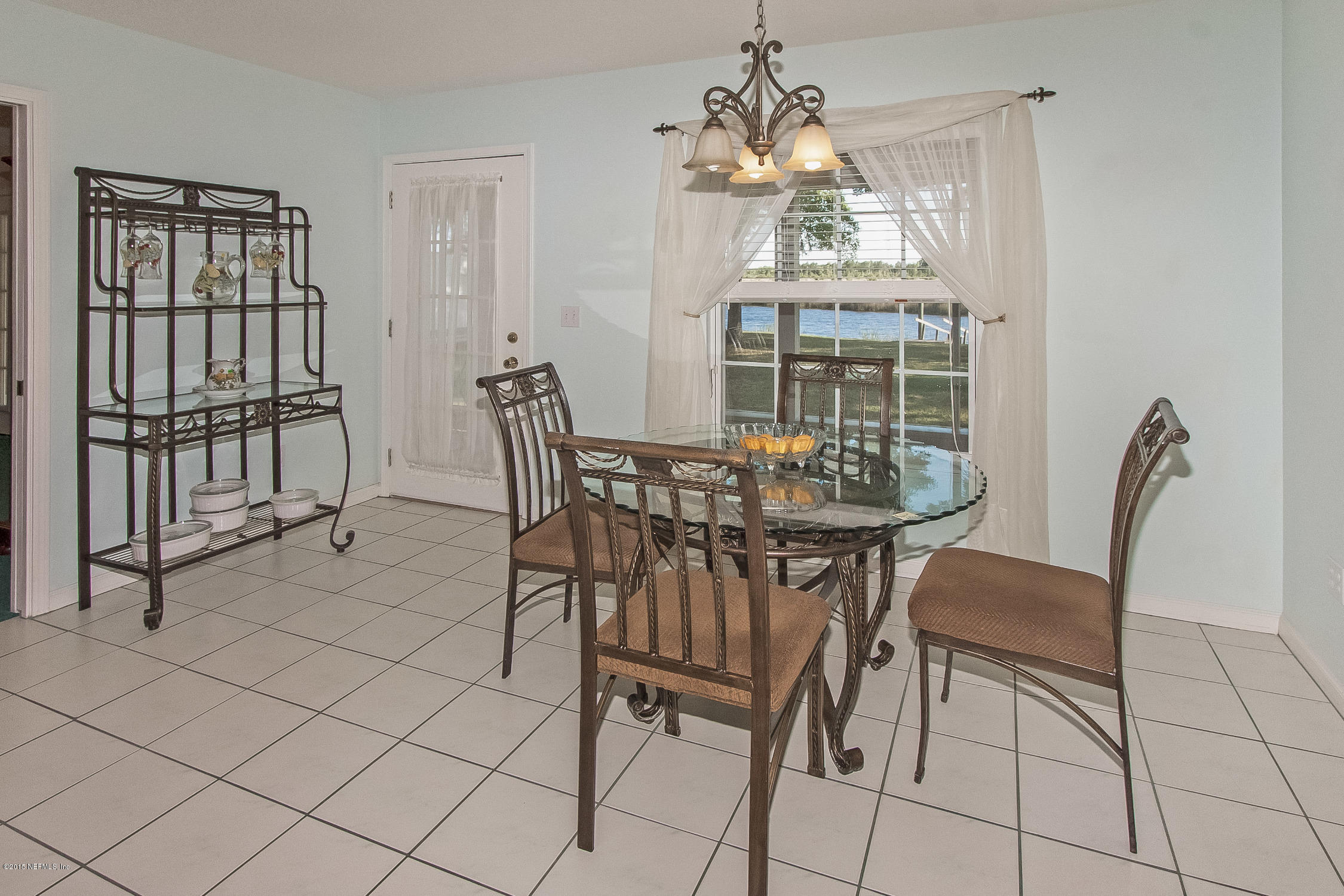 75109 Edwards Road Yulee, FL 32097 - Photo 8 of 30 a view of a dining room with furniture and chandelier
