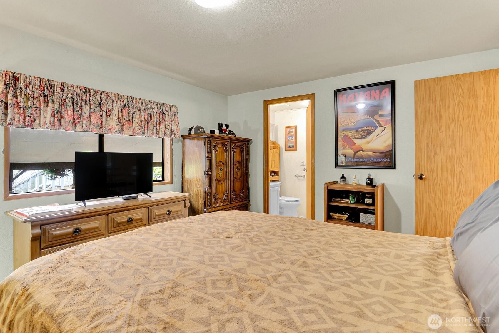 1427 100th Street Southwest, Unit 160 Everett, WA 98204 - Photo 14 of 28 a bedroom with a bed and a flat screen tv