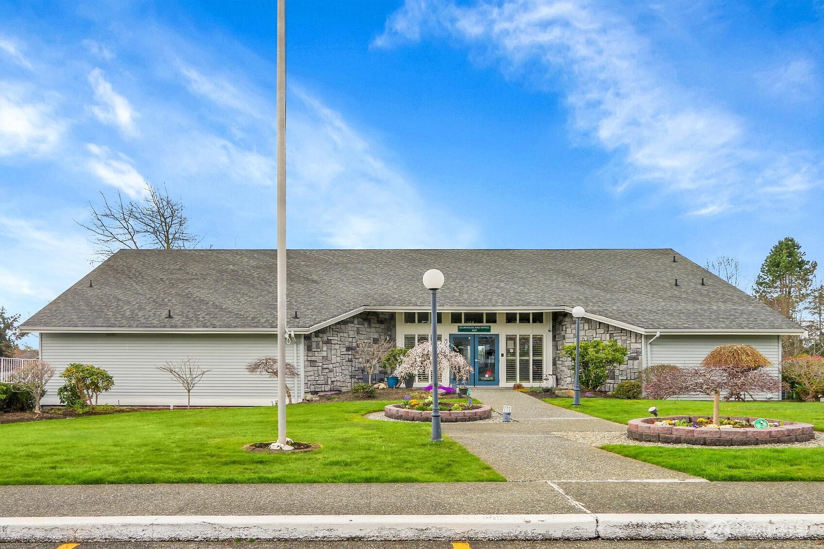 1427 100th Street Southwest, Unit 160 Everett, WA 98204 - Photo 21 of 28 a front view of a house with a yard table and chairs