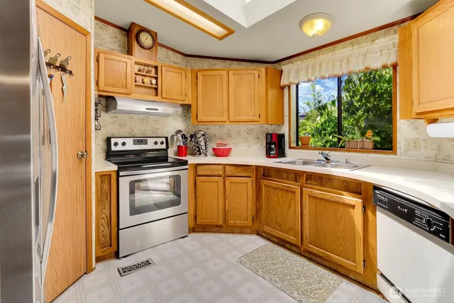 a kitchen with stainless steel appliances a stove sink and cabinets