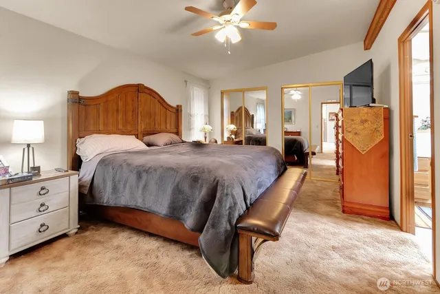 a bedroom with a bed dresser and a window