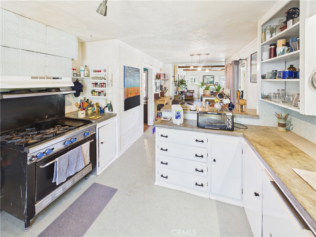 4208 Ramsden Road Mariposa, CA 95338 - Photo 12 of 42 a kitchen with stainless steel appliances a stove oven and white cabinets