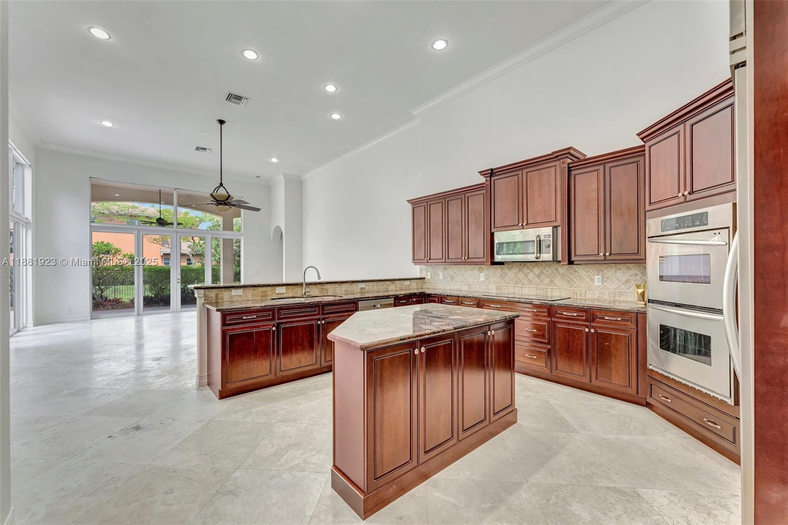 3203 West Stonebrook Circle Davie, FL 33330 - Photo 11 of 51 a kitchen with stainless steel appliances granite countertop a stove a sink and a refrigerator