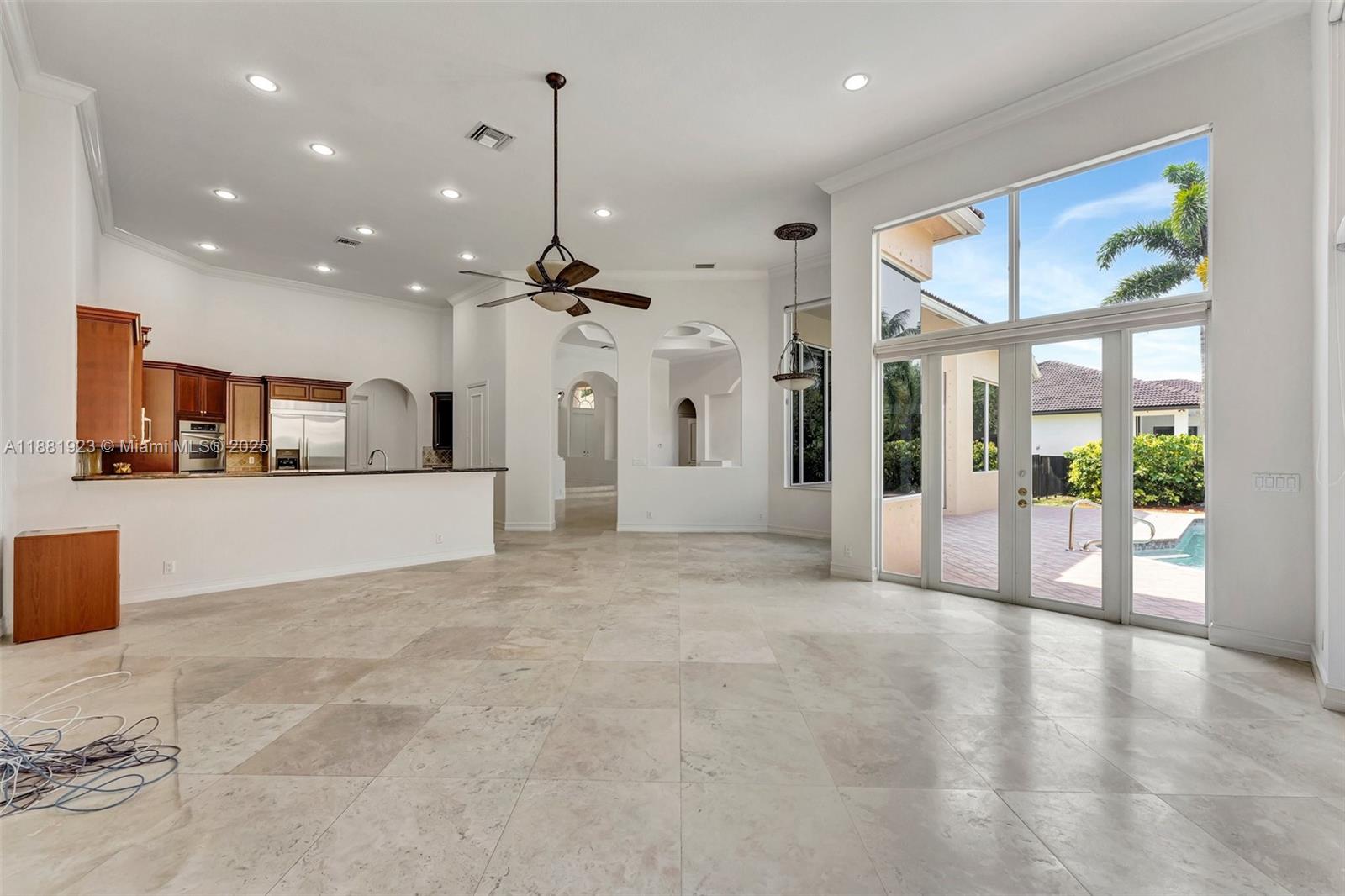 3203 West Stonebrook Circle Davie, FL 33330 - Photo 14 of 51 a view of a living room and kitchen with stainless steel appliances