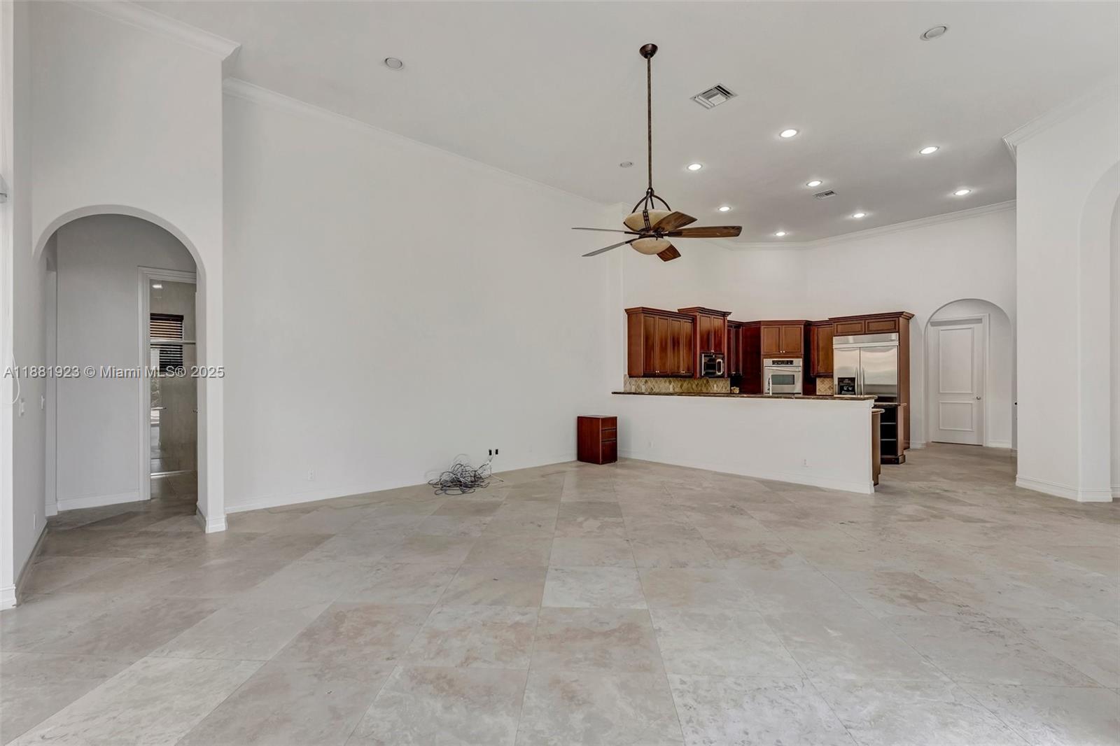 3203 West Stonebrook Circle Davie, FL 33330 - Photo 16 of 51 a view of a kitchen with a refrigerator and a fireplace