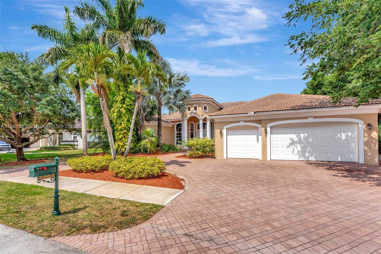 3203 West Stonebrook Circle Davie, FL 33330 - Photo 2 of 51 a front view of a house with garden