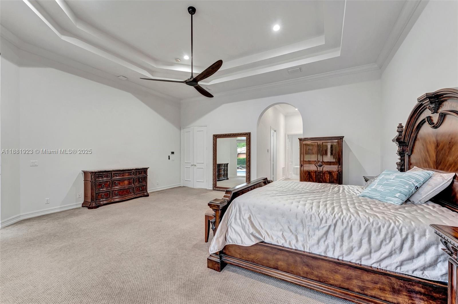 3203 West Stonebrook Circle Davie, FL 33330 - Photo 21 of 51 a bedroom with a bed and a chandelier