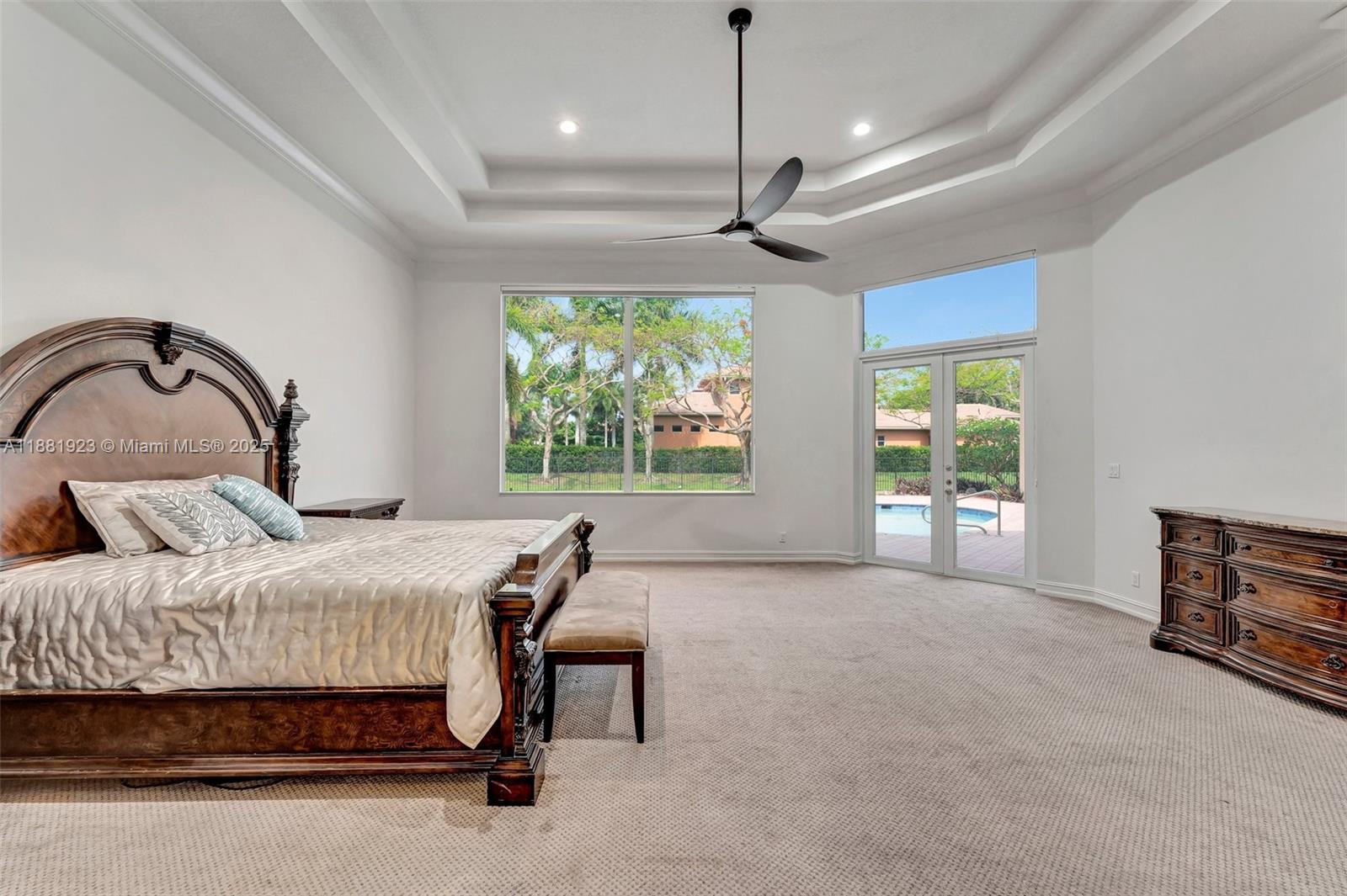 3203 West Stonebrook Circle Davie, FL 33330 - Photo 22 of 51 a bedroom with a large bed and a chandelier