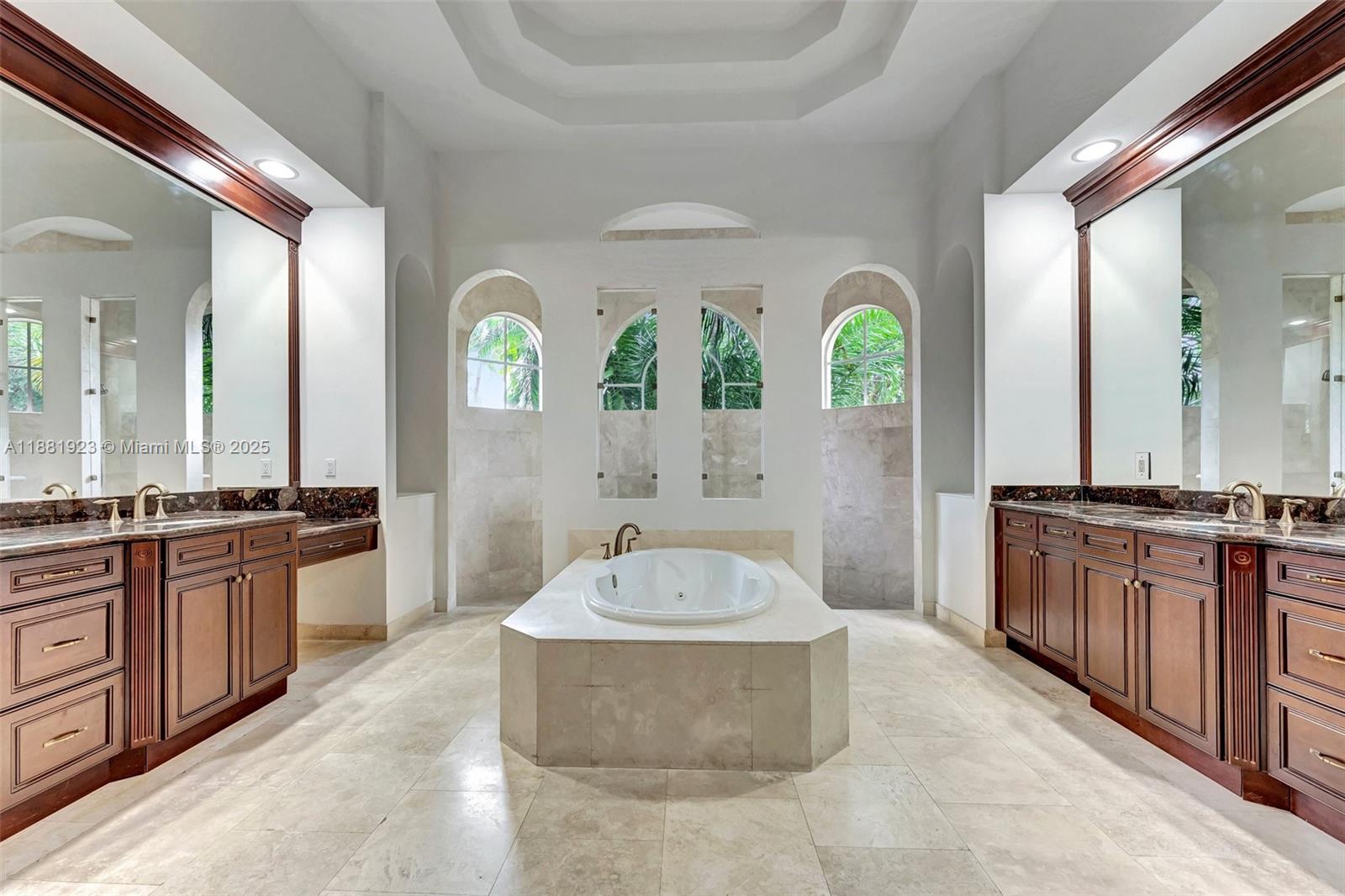 3203 West Stonebrook Circle Davie, FL 33330 - Photo 25 of 51 a spacious bathroom with a granite countertop tub and a large mirror