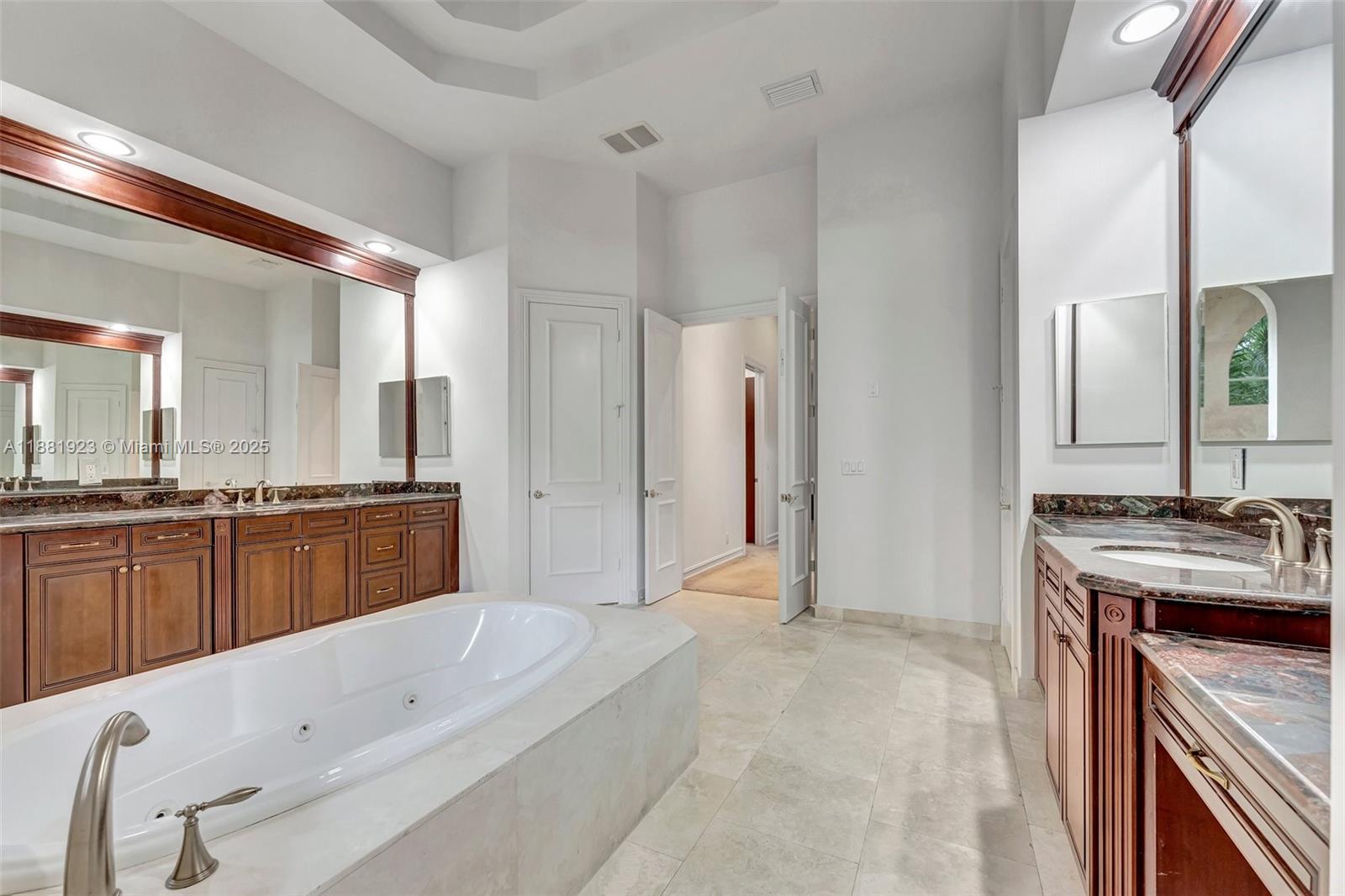 3203 West Stonebrook Circle Davie, FL 33330 - Photo 27 of 51 a bathroom with a tub a sink a mirror and a shower