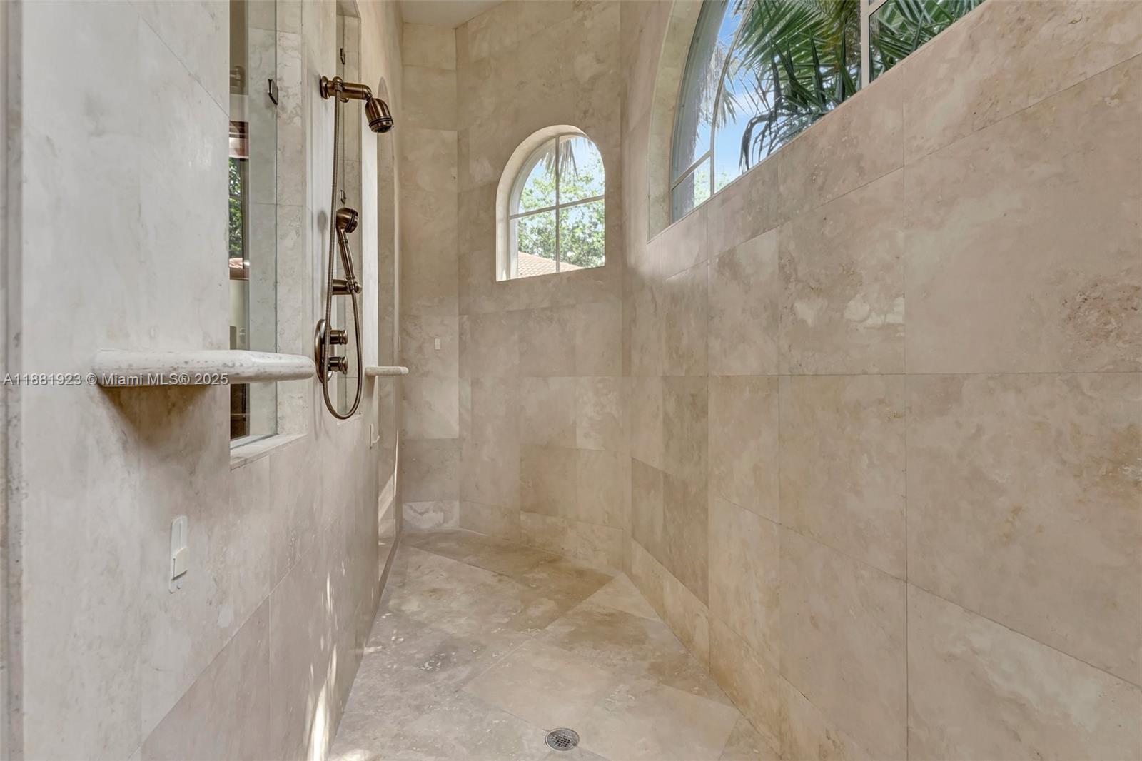 3203 West Stonebrook Circle Davie, FL 33330 - Photo 28 of 51 a bathroom with a granite countertop shower a sink and a window