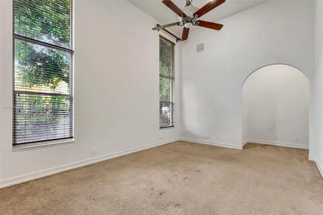 an empty room with an entryway and closet area