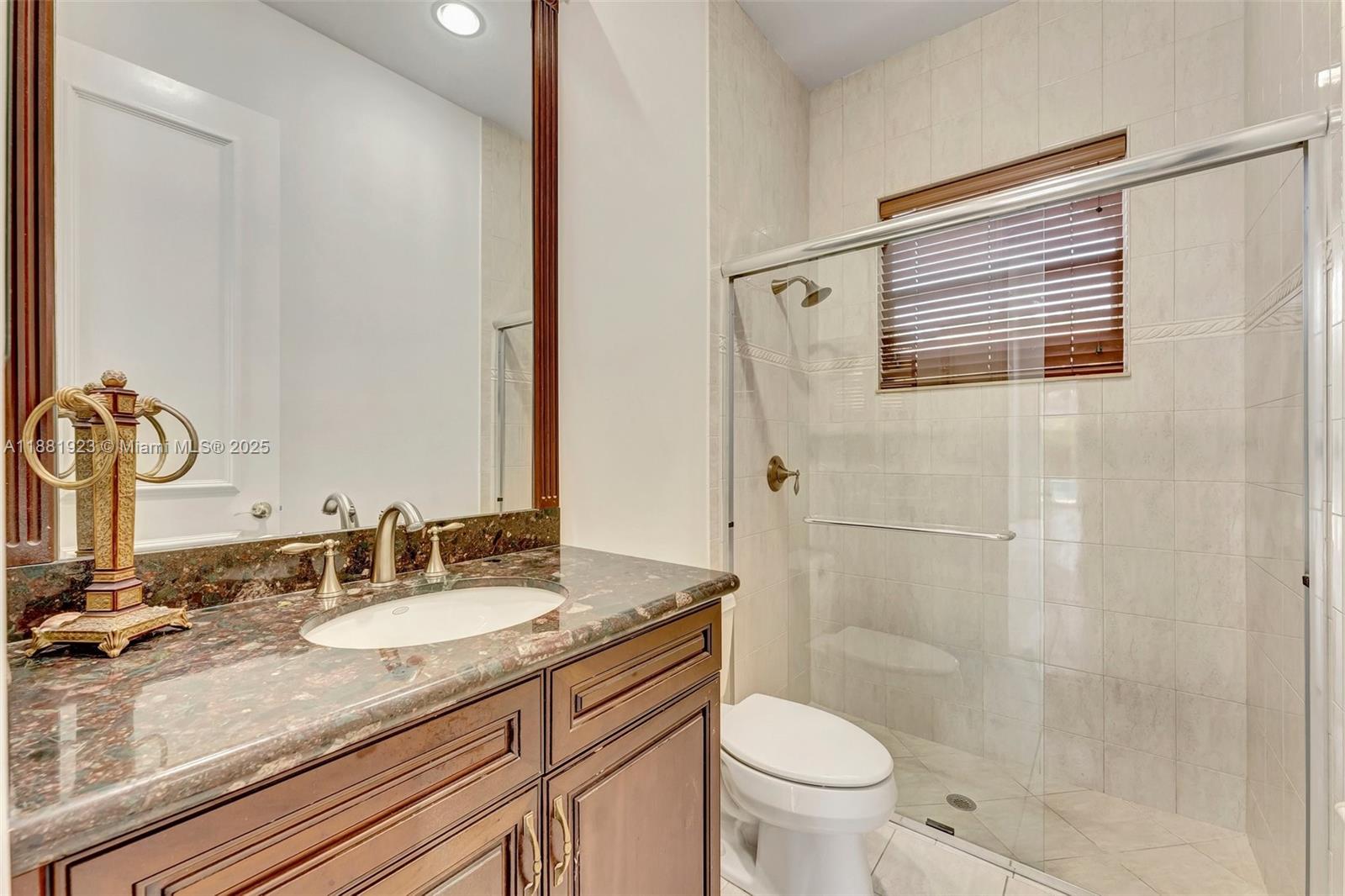 3203 West Stonebrook Circle Davie, FL 33330 - Photo 34 of 51 a bathroom with a granite countertop sink toilet and shower