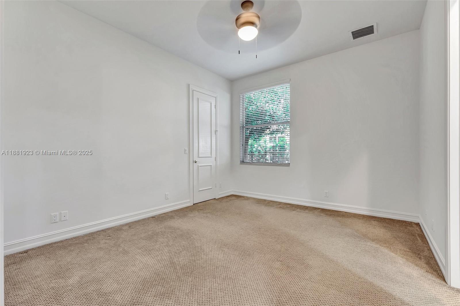 3203 West Stonebrook Circle Davie, FL 33330 - Photo 36 of 51 an empty room with windows and chandelier fan