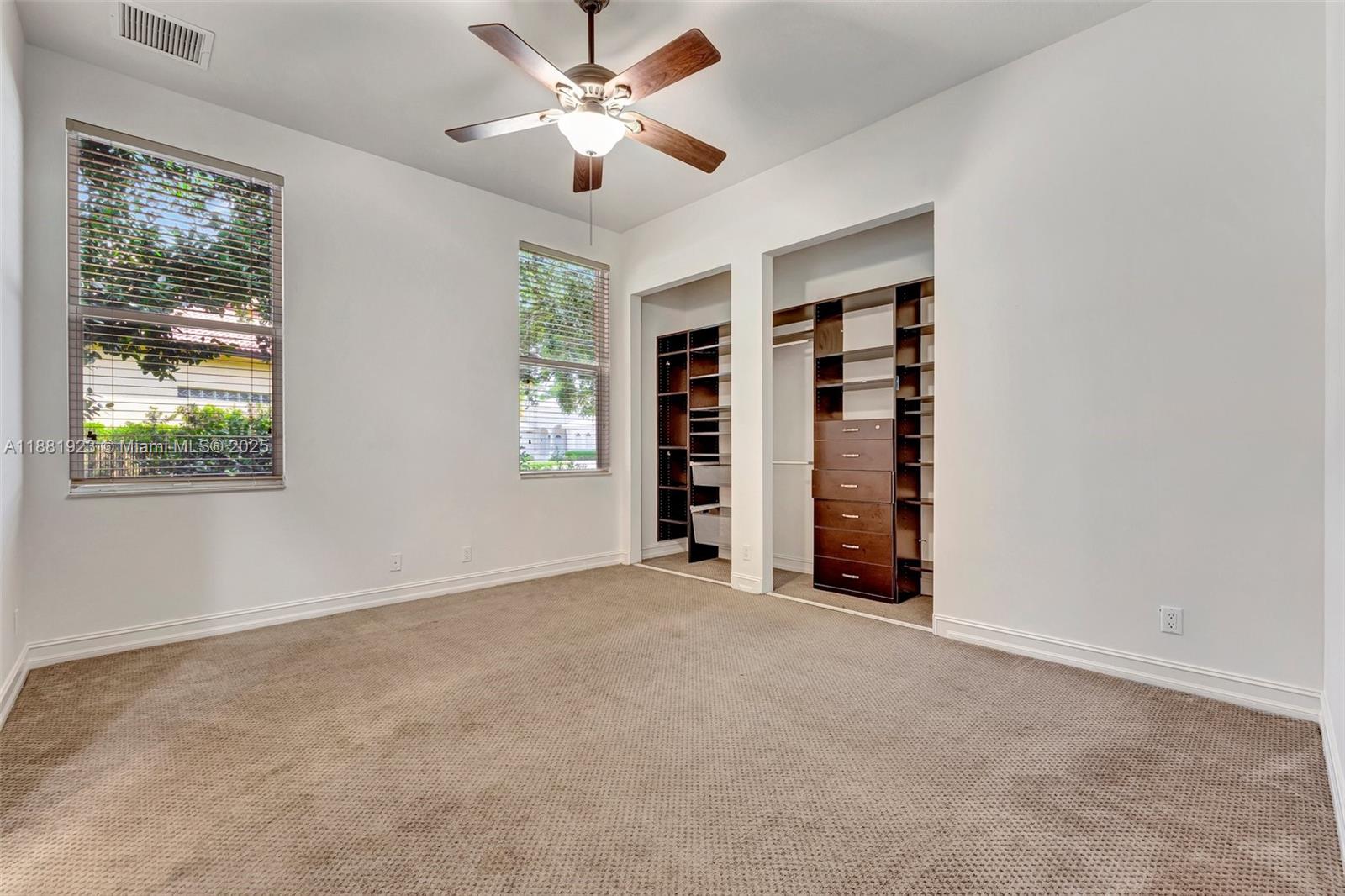 3203 West Stonebrook Circle Davie, FL 33330 - Photo 37 of 51 an empty room with a window and a ceiling fan