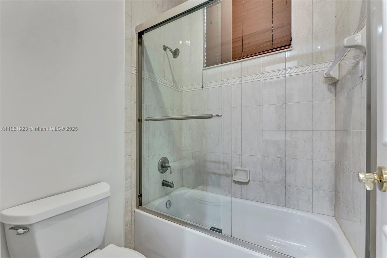 3203 West Stonebrook Circle Davie, FL 33330 - Photo 39 of 51 a bathroom with a bathtub and a toilet