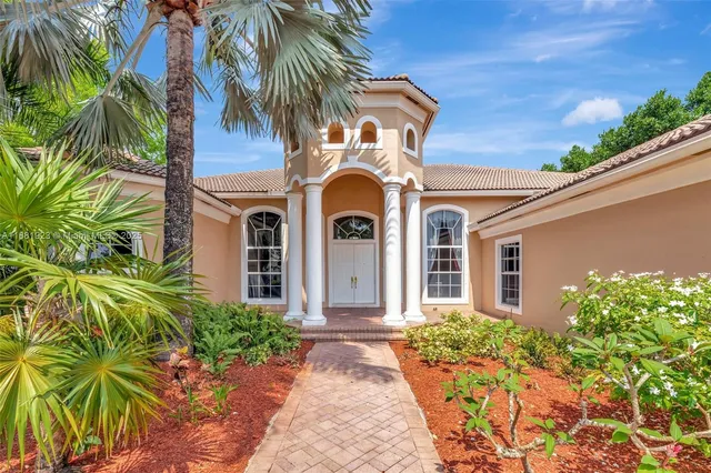 a front view of a house with a garden